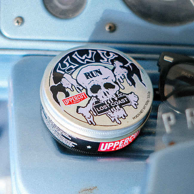 HWY x Uppercut Deluxe Tin sitting on Dashboard of Car