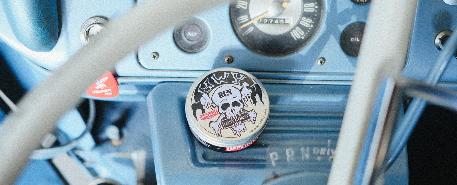 HWYxUCD tin siting on dashboard of car