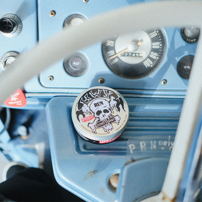 HWYxUCD tin siting on dashboard of car